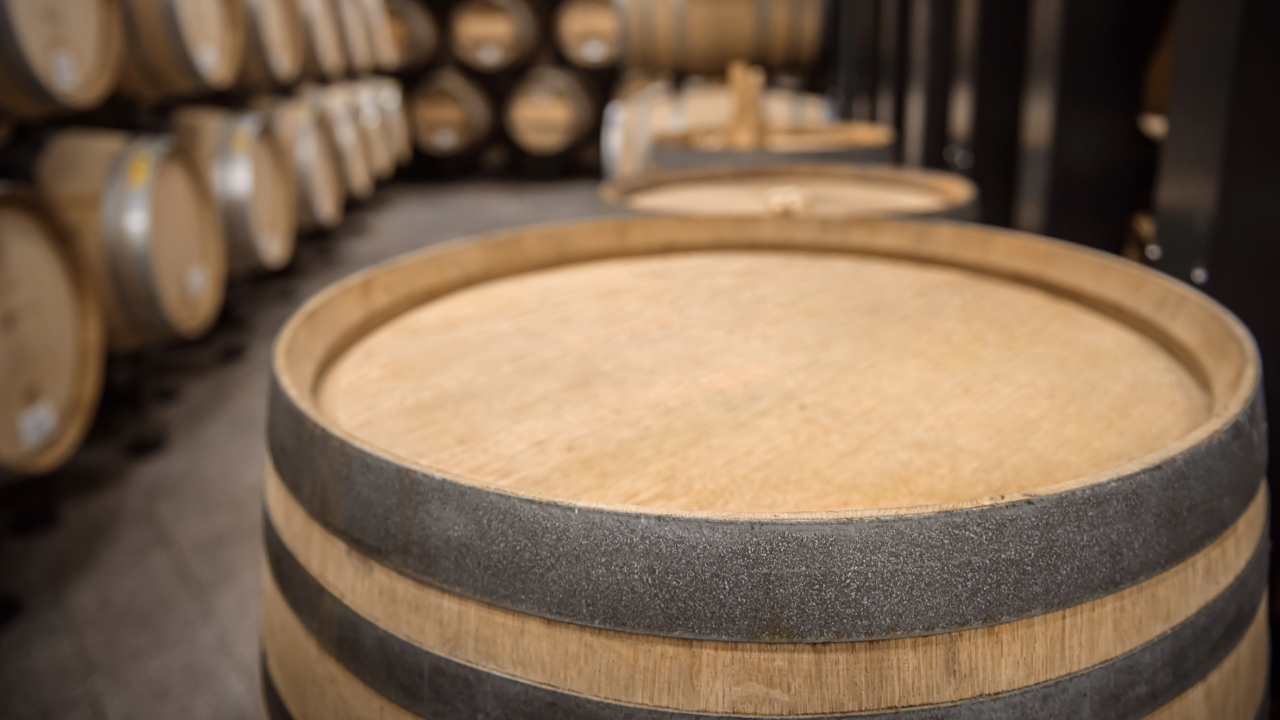 A close up of the top of an aging barrel with more in the background