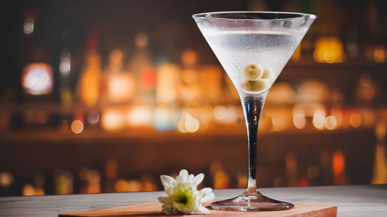 A close up of a Martini, one of the best bar drinks of 2024, with olives and garnish