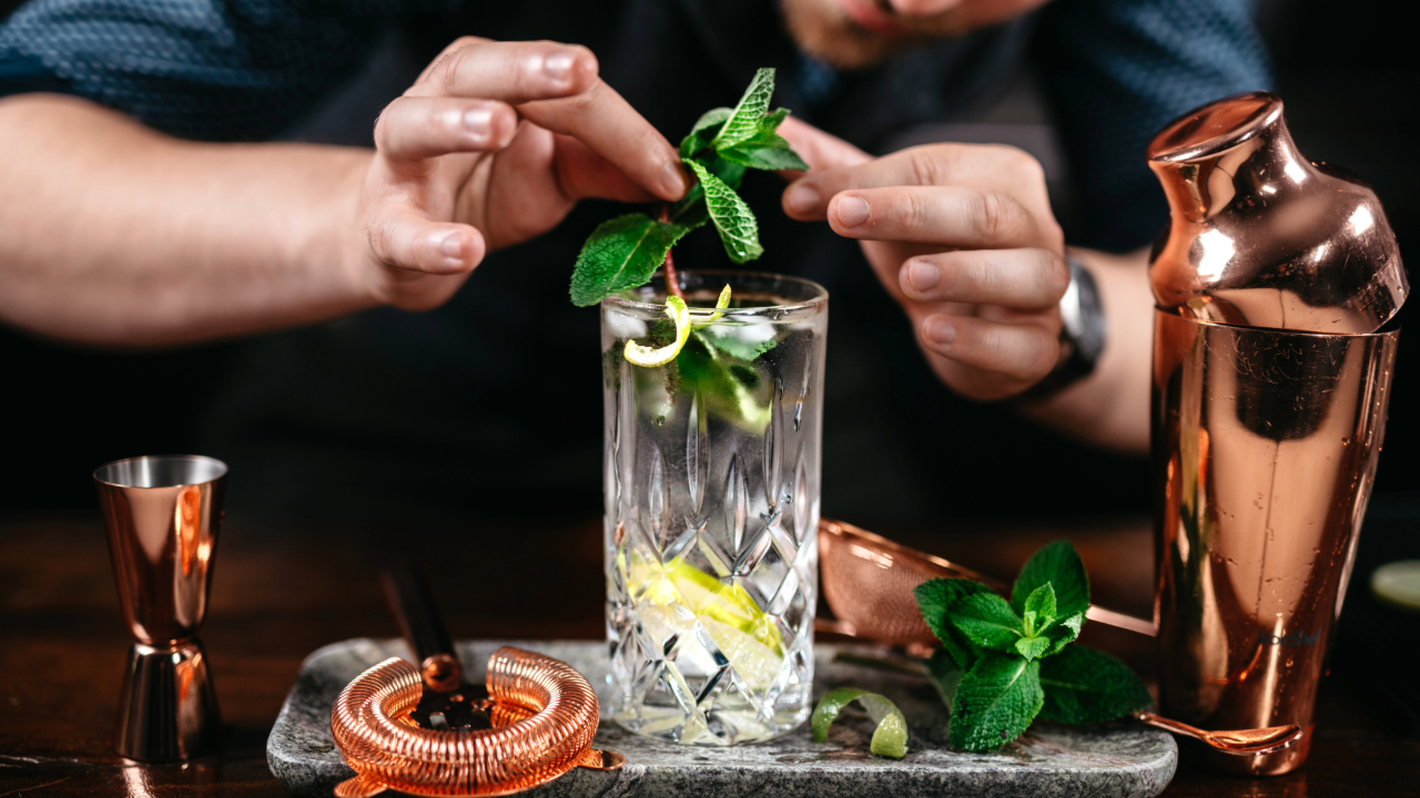 A professional bartender carefully selecting the perfect garnish for the perfect cocktail