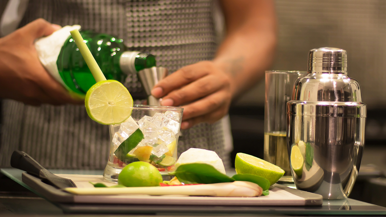 A close up of a man creating cocktails