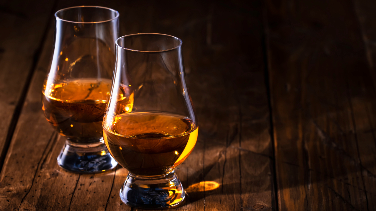 Two elegant Glencairn glasses filled with premium bourbon whiskey for tasting