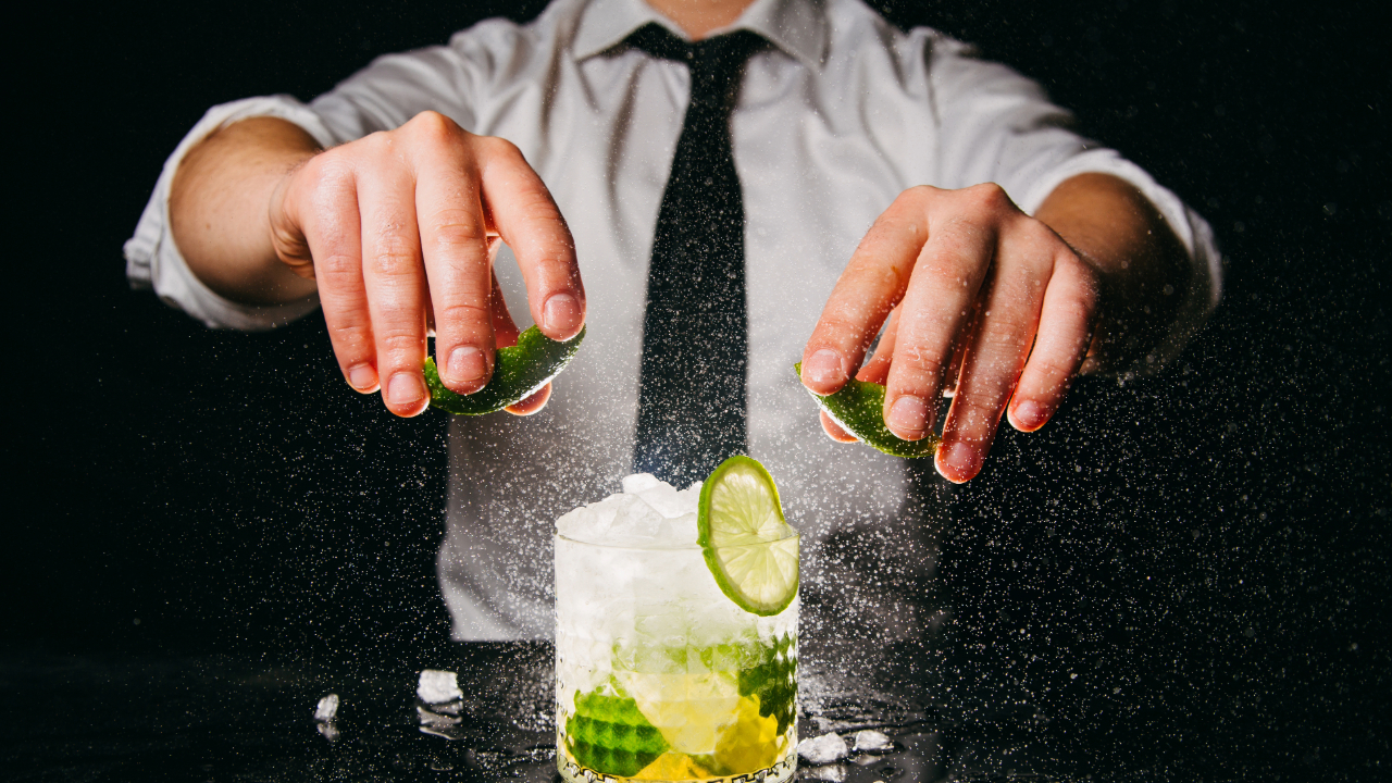 A dramatic shot of a bartender in a suit Making Cocktails