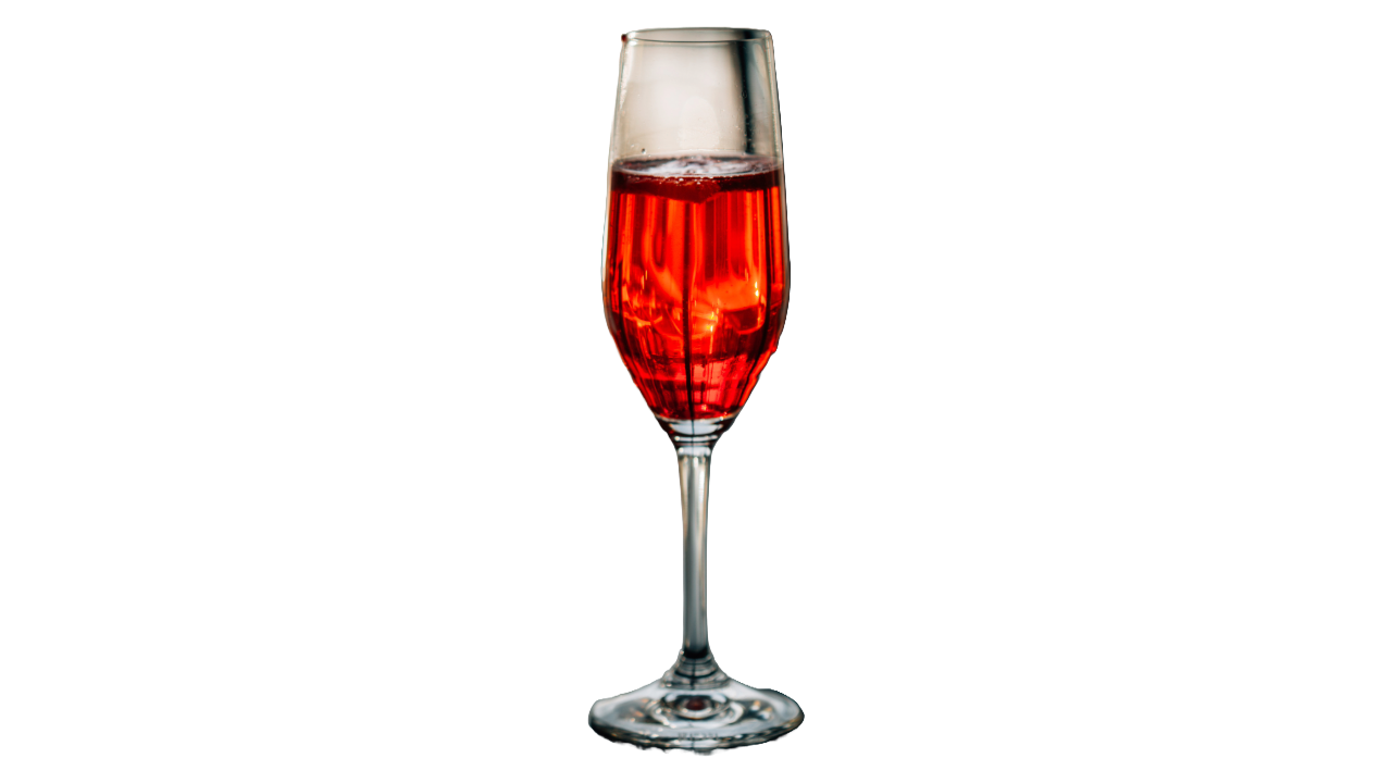 A romantic Kir Royale cocktail in front of a plain white background