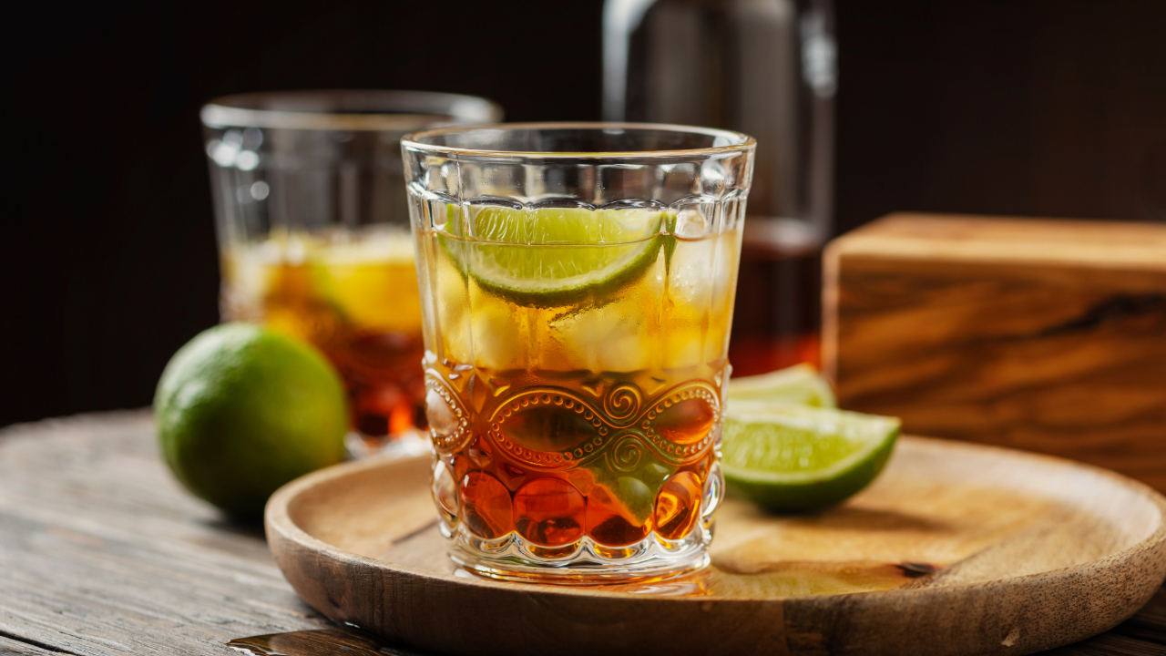 An elegant glass of celebratory Rum with limes and tropical fruit