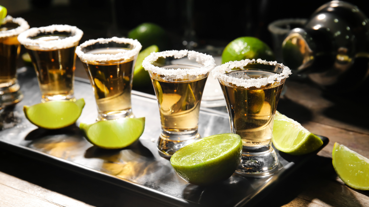 A flight of high end tequila shots with salt around the rims and limes